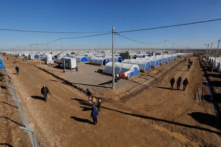 Displaced Iraqis who fled the Islamic State stronghold of Mosul walk in Khazer camp, east of Mosul, Iraq. REUTERS/Muhammad Hamed