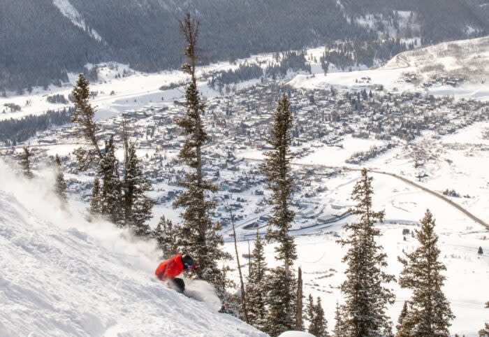 A skier rides above the town of Crested Butte on The Extremes