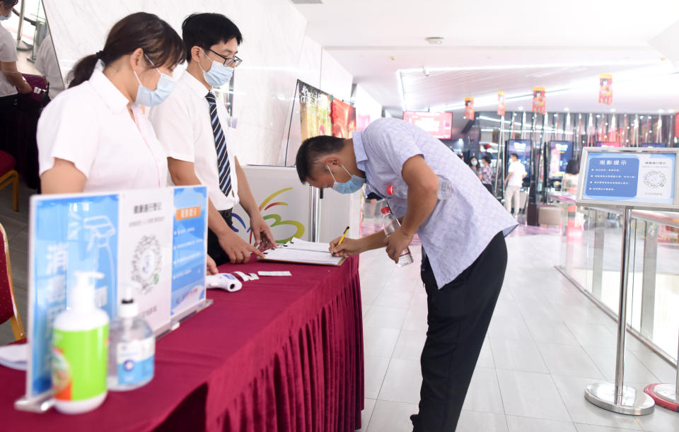 GUANGZHOU, July 20, 2020  -- A customer registers his health information before entering a movie theater which has reopened in Guangzhou, south China's Guangdong Province, July 20, 2020.   Some movie theaters have reopened on Monday in Guangzhou on the premise that proper prevention and control measures have been put into place.(Photo by Lu Hanxin/Xinhua via Getty) (Xinhua/Lu Hanxin via Getty Images)