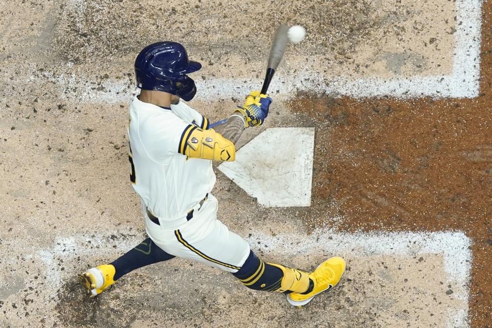 Milwaukee Brewers' Kolten Wong hits a single during the fourth inning of a baseball game against the Chicago Cubs Tuesday, July 5, 2022, in Milwaukee. (AP Photo/Morry Gash)