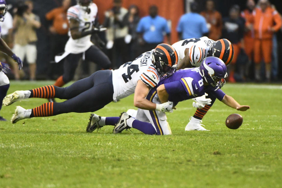 Minnesota Vikings quarterback Kirk Cousins (8) fumbles as he is sacked by Chicago Bears inside linebacker Nick Kwiatkoski, left, while Bears outside linebacker Leonard Floyd gets in on the play during the second half of an NFL football game Sunday, Sept. 29, 2019, in Chicago. The Vikings kept possession of the ball.(AP Photo/Matt Marton)