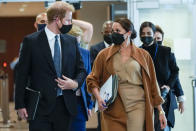 Prince Harry and Meghan, the Duke and Duchess of Sussex are escorted as they leave the United Nations headquarters after a visit during 76th session of the United Nations General Assembly, Saturday, Sept. 25, 2021. (AP Photo/Mary Altaffer)