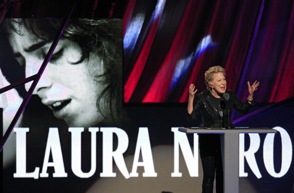 Bette Midler introduces the late Laura Nyro for induction into the Rock and Roll Hall of Fame Saturday, April 14, 2012, in Cleveland. (AP Photo/Tony Dejak)