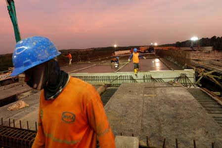 Labourers work at a construction site of Balikpapan-Samarinda toll road at Samboja district in Kutai Kertanegara regency
