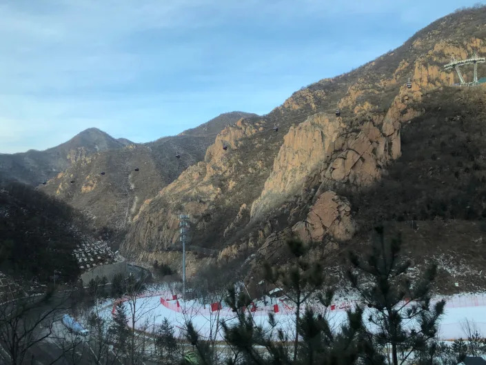 Slopes for the Beijing Olympics cut through jagged rock, with no snow in sight other than the artificial snow created just for these Games. (Yahoo Sports)