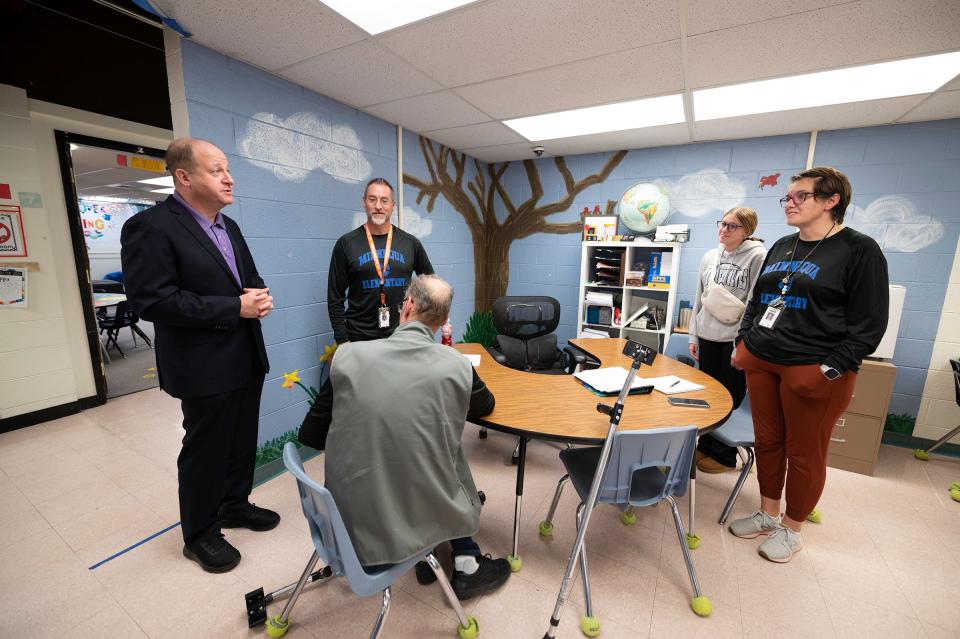 Gov. Jared Polis, left, visits with Minnequa Elementary School faculty on Friday, January 26, 2024.