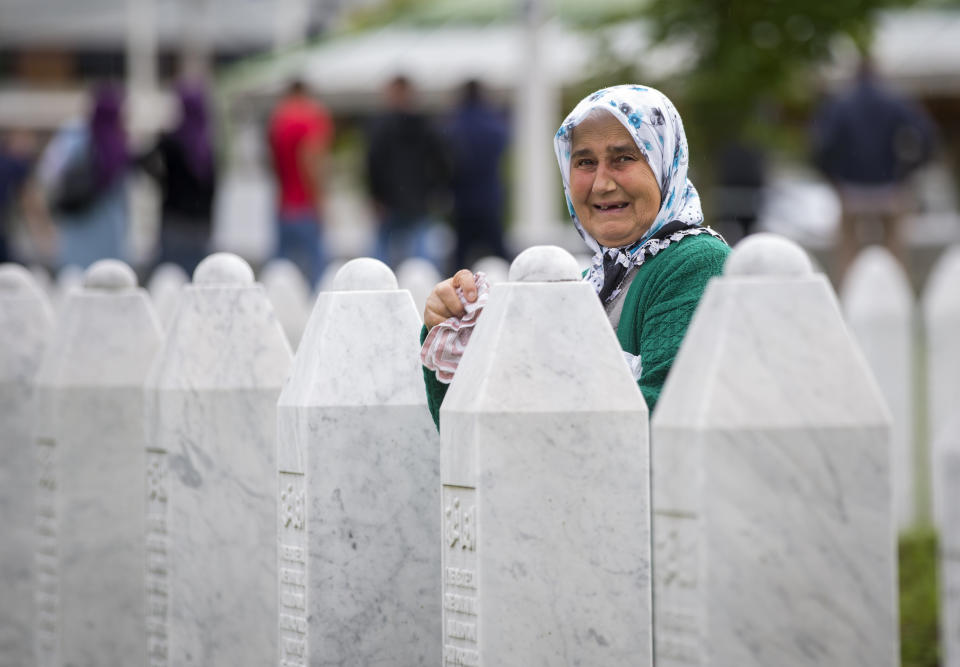 A woman cries at the memorial cemetery in Potocari, near Srebrenica, Bosnia, Wednesday, July 10, 2019. The remains of 33 victims of Srebrenica massacre will be buried on July 11, 2019, 24 years after Serb troops overran the eastern Bosnian Muslim enclave of Srebrenica and executed some 8,000 Muslim men and boys, which international courts have labeled as an act of genocide. (AP Photo/Darko Bandic)