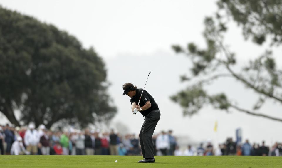 Phil Mickelson hits his second shot from the fairway of the second hole of the south course during the second round of the Farmers Insurance Open golf tournament Friday, Jan. 24, 2014, in San Diego. (AP Photo/Gregory Bull)