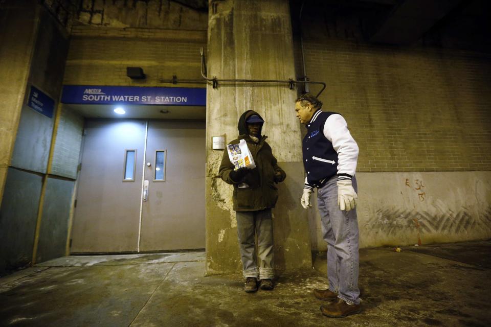 Doctor Angelo checks on a homeless man under the overpasses on Lower Wacker Drive in Chicago