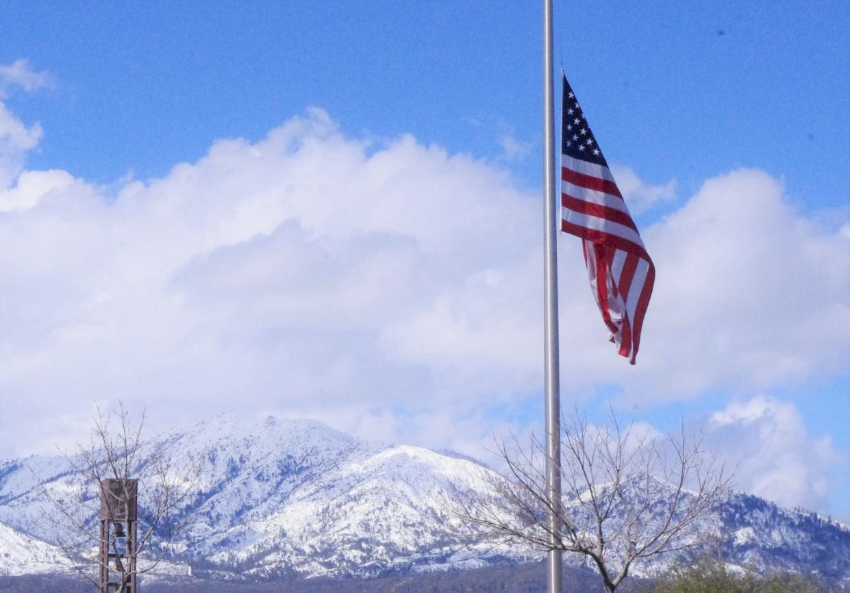 Snow-capped mountains rise in the distance north of the Northern California Veterans Cemetery on Thursday, March 30, 2023.