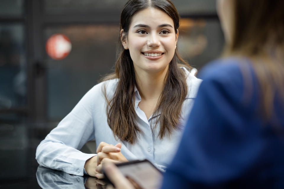 Determine Earning Power and Professional Growth Opportunities.  A new female employee on a job interview final round with an HR officer in a business office.