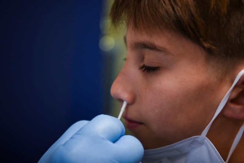 FILE PHOTO: Atlas Smookler receives a coronavirus disease (COVID-19) test at the Austin Jewish Academy as the spread of the Omicron variant leads to teacher shortages amid the COVID-19 pandemic in Austin, Texas, U.S