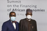 The president of the African Development Bank Akinwumi Adesina, left, and Nigeria's President Muhammadu Buhari pose before the opening session at the Summit on the Financing of African Economies Tuesday, May 18, 2021 in Paris. More than twenty heads of state and government from Africa are holding talks in Paris with heads of international organizations on how to revive the economy of the continent, deeply impacted by the consequences of the COVID-19 pandemic. (Photo by Ludovic Marin, Pool via AP)