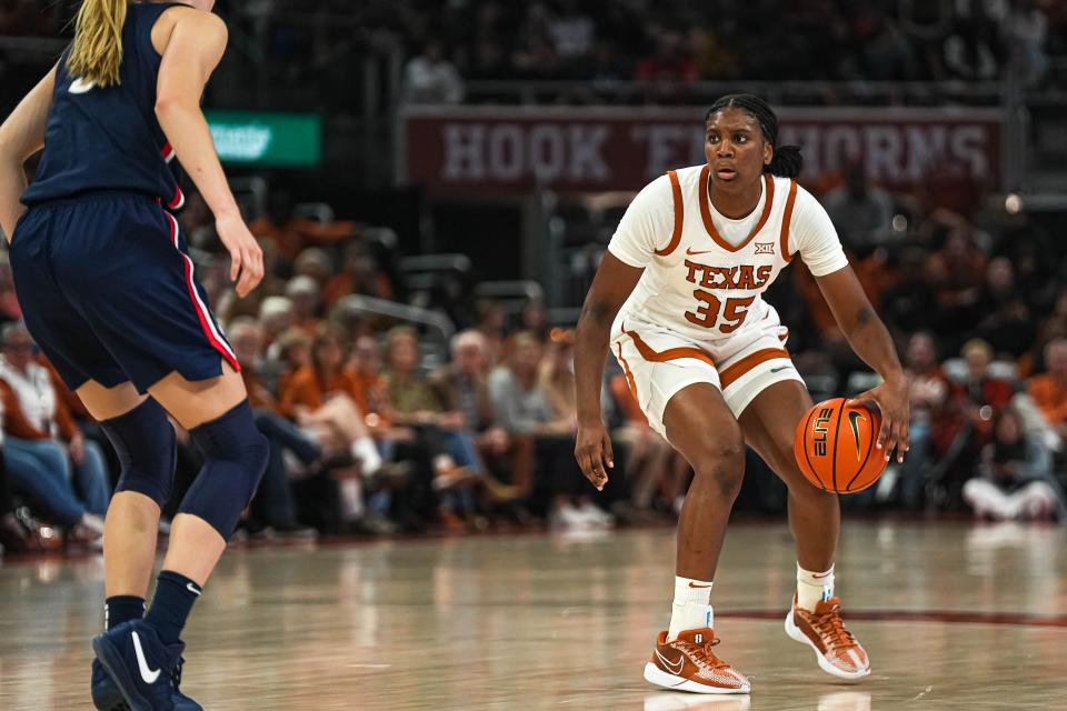 Texas guard Madison Booker is guarded by UConn guard Paige Bueckers during their game at Moody Center last December. Booker earned a spot on the Associated Press' All-America second team on Wednesday.