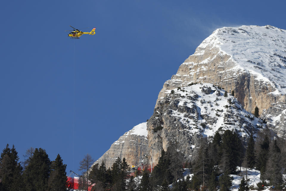 Rescue helicopter evacuate United States' Isabella Wright after she crashed during an alpine ski, women's World Cup downhill race, in Cortina d'Ampezzo, Italy, Saturday, Jan. 27, 2024. (AP Photo/Alessandro Trovati)