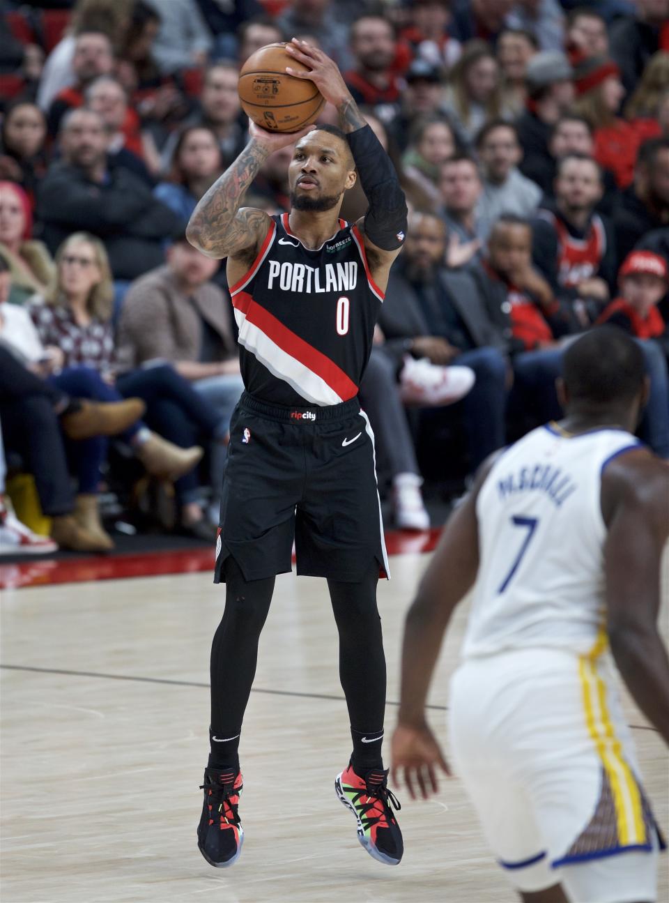 Portland Trail Blazers guard Damian Lillard shoots a 3-point basket against the Golden State Warriors during the second half of an NBA basketball game in Portland, Ore., Monday, Jan. 20, 2020. (AP Photo/Craig Mitchelldyer)
