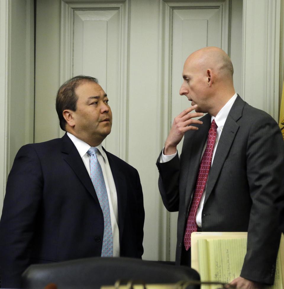 Attorney Reid Schar, right, talks with New Jersey Sen. Kevin J. O'Toole, R-Wayne, N.J., before a meeting of a joint bipartisan committee of members of the New Jersey Senate and Assembly, at the Statehouse in Trenton, N.J., Monday, Feb. 10, 2014. More subpoenas are expected to be issued by the New Jersey legislative committee investigating a plot to create gridlock by blocking lanes near the George Washington Bridge. (AP Photo/Mel Evans)