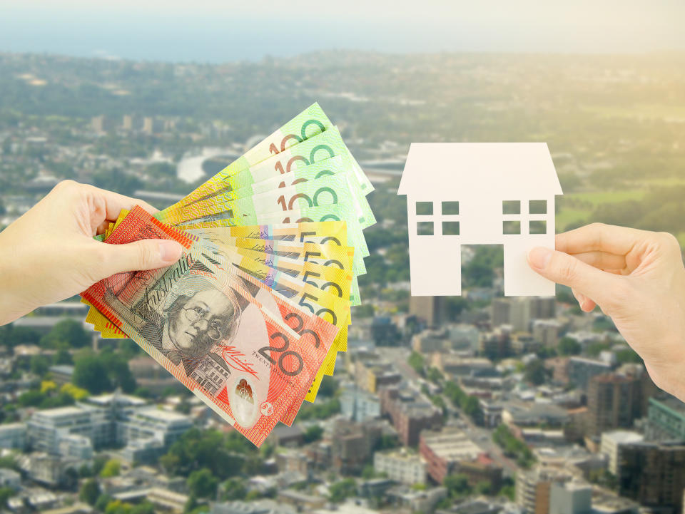 Client giving Australian money to property agent for buying house. 