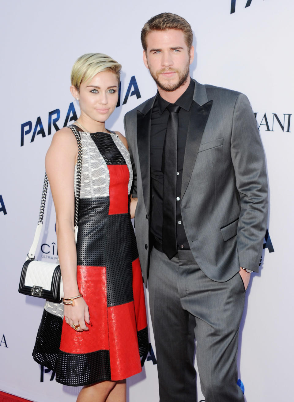 Singer Miley Cyrus and actor Liam Hemsworth arrive at the Los Angeles Premiere "Paranoia" at DGA Theater on Aug. 8, 2013 in Los Angeles, California.&nbsp;