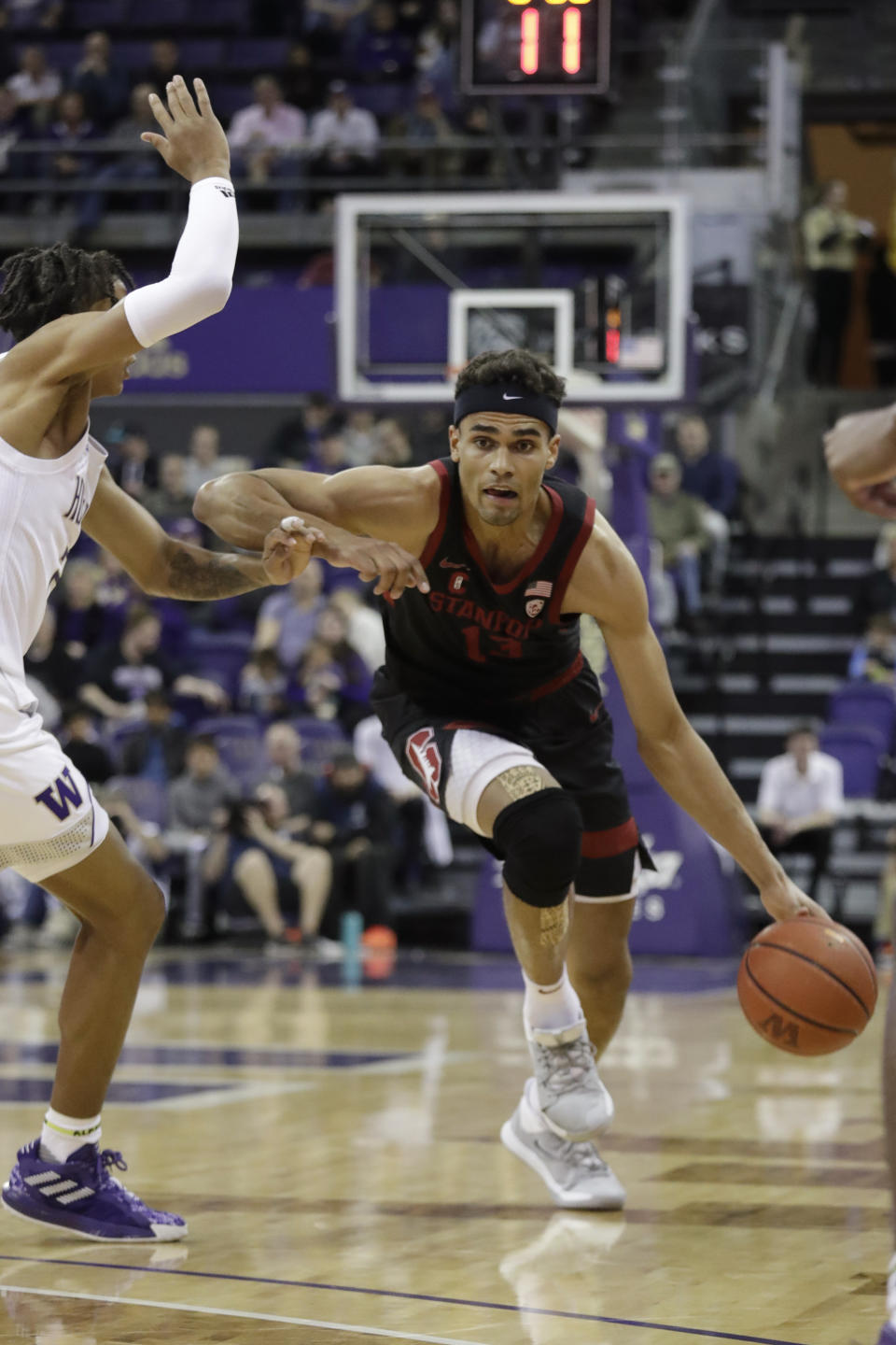 Stanford's Oscar da Silva, right, tries to get past Washington's RaeQuan Battle during the first half of an NCAA college basketball game Thursday, Feb. 20, 2020, in Seattle. (AP Photo/Elaine Thompson)