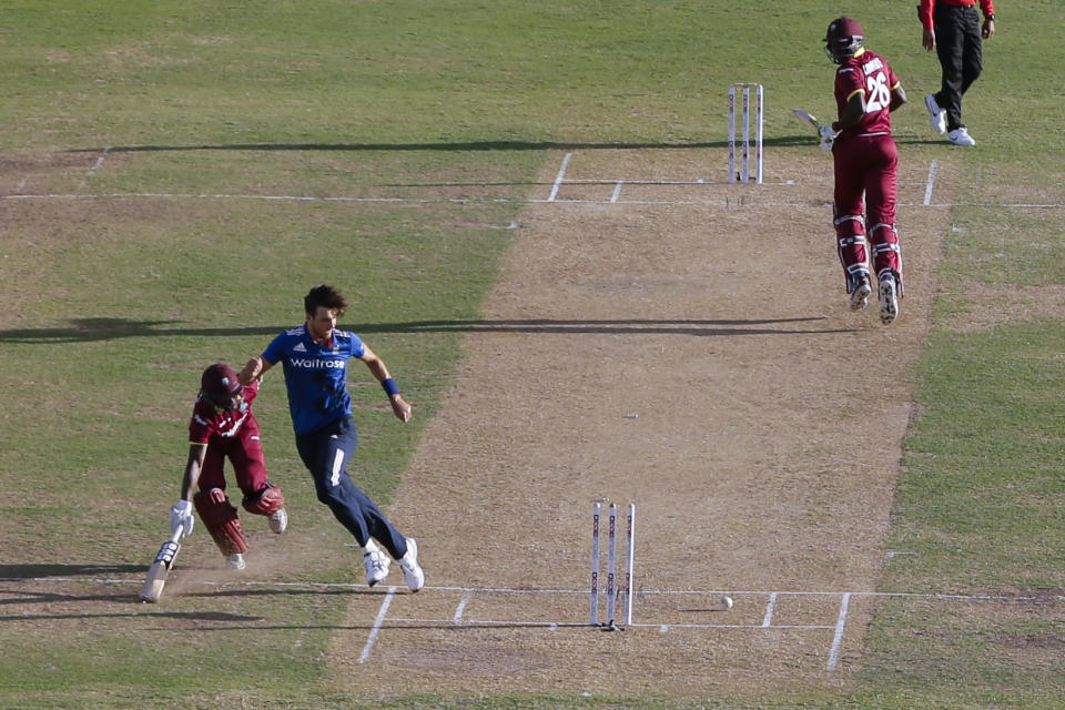 England's Steven Finn kicks the ball to hit the wicket and run out West Indies' Jason Mohammed during a one day international cricket match at the Sir Vivian Richards Stadium in North Sound, Antigua, Friday, March 3, 2017. (AP Photo/Ricardo Mazalan)