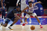 Minnesota Timberwolves center Naz Reid, left, and Detroit Pistons guard Saben Lee (38) chase the loose ball during the second half of an NBA basketball game, Tuesday, May 11, 2021, in Detroit. (AP Photo/Carlos Osorio)