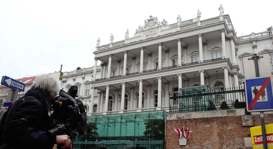 A cameraman films outside Palais Coburg hotel where nuclear talks are taking place in Vienna February 19, 2014. Six world powers and Iran began "substantive" talks on Tuesday in pursuit of a final settlement on Tehran's contested nuclear programme in the coming months despite caveats from both sides that a breakthrough deal may prove impossible. REUTERS/Heinz-Peter Bader (AUSTRIA - Tags: POLITICS ENERGY)