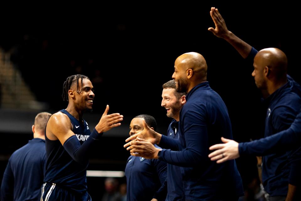 Xavier Musketeers guard Paul Scruggs (1) high fives coaches and teammates as he leaves the game in the second half of the NCAA men's basketball game on Friday, Jan. 7, 2022, at Hinkle Fieldhouse in Indianapolis, Ind. Xavier Musketeers defeated Butler Bulldogs 87-72. 