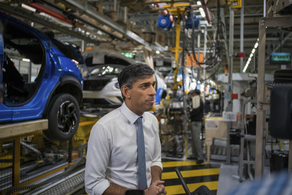 Britain's Prime Minister Rishi Sunak, speaks to media as he visits the car manufacturer Nissan, in Sunderland, England, Friday, Nov. 24, 2023. Nissan will invest more than $1.3 billion to update its factory in northeast England to make electric versions of its two best-selling cars. It's a boost for the British government as it tries to revive the country’s ailing economy. The Japanese automaker manufactures the gasoline-powered Qashqai and smaller Juke crossover vehicles at the factory in Sunderland, which employs 6,000 workers. (Ian Forsyth/Pool Photo via AP)