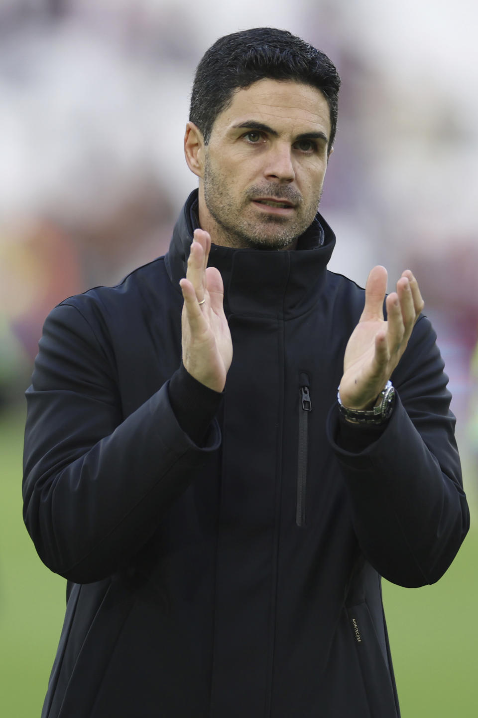 Arsenal's manager Mikel Arteta applauds the fans after the end of the English Premier League soccer match between West Ham United and Arsenal at the London Stadium in London, Sunday, Feb. 11, 2024. Arsenal won the game 6-0. (AP Photo/Ian Walton)