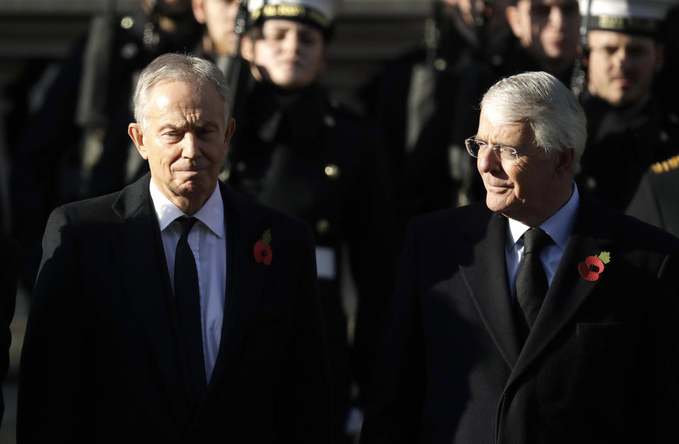 FILE - In this Sunday, Nov. 10, 2019 file photo, former British Prime Ministers Tony Blair, left and John Major attend the Remembrance Sunday ceremony at the Cenotaph in Whitehall in London. Remembrance Sunday is held each year to commemorate the service men and women who fought in past military conflicts. The two former British prime ministers who played crucial roles in bringing peace to Northern Ireland joined forces Sunday, Sept. 13, 2020 to urge lawmakers to reject government plans to over-ride the Brexit deal with the European Union, arguing that it imperils that peace as well as damaging the U.K.’s reputation. (AP Photo/Matt Dunham, File)