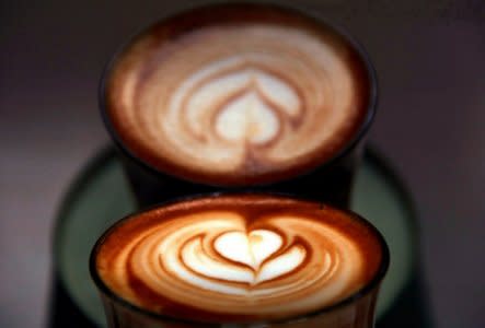 A photo illustration shows a coffee reflected in a coffee machine after it was made for a customer at a Sydney cafe in Australia, May 4, 2017. REUTERS/David Gray/Illustration