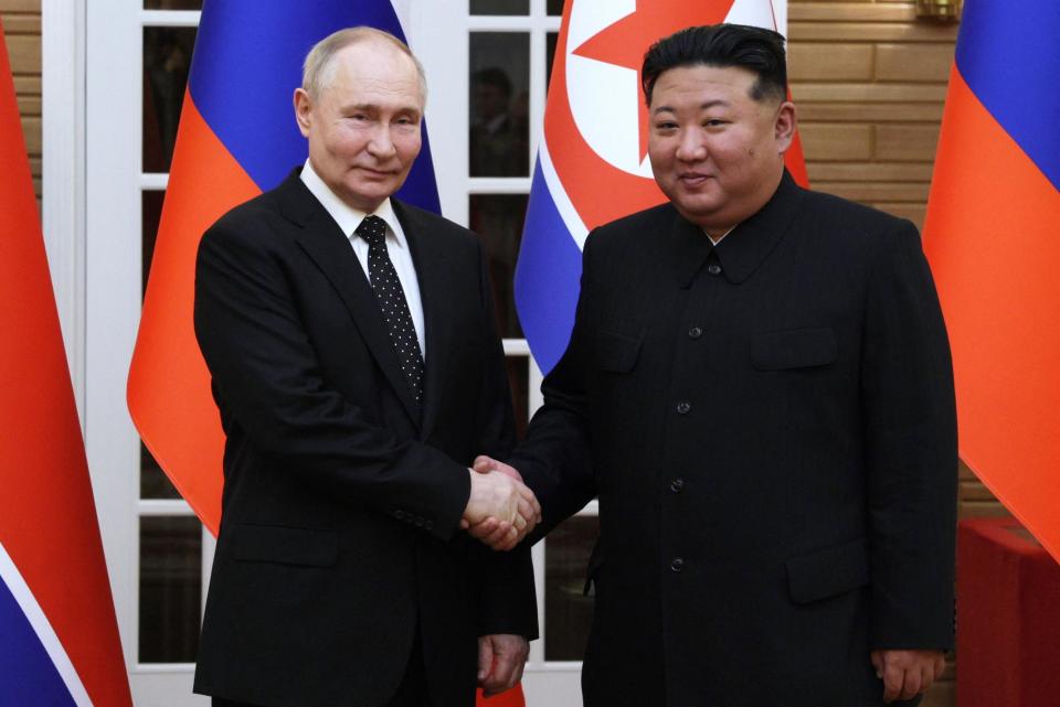 A pool photograph distributed by the Russian state agency Sputnik shows North Korean leader Kim Jong Un and Russian President Vladimir Putin shaking hands after a welcoming ceremony at Kim Il Sung Square in Pyongyang, North Korea, June 19, 2024. / Credit: GAVRIIL GRIGOROV/POOL/AFP/Getty