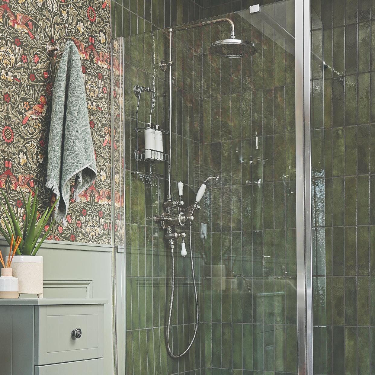  A green-tiled bathroom with a shower. 