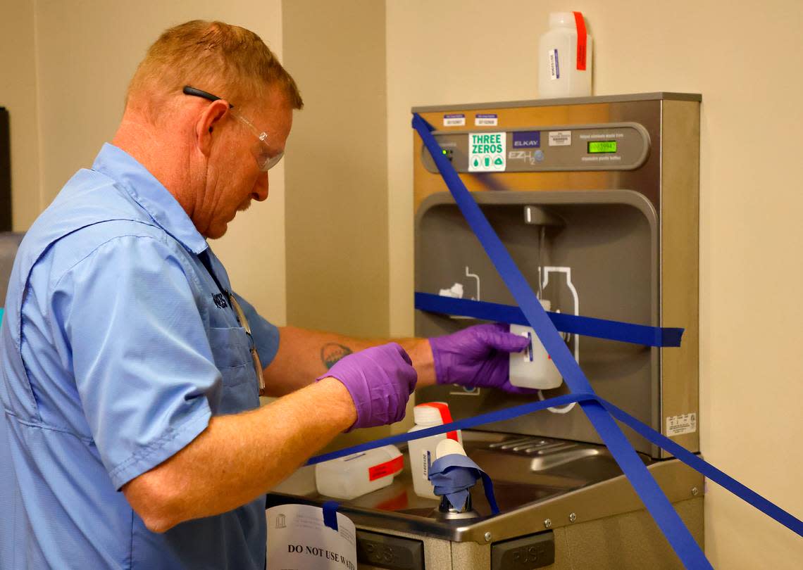 David Catalano, a field hygienist with UNC’s Department of Environment, Health and Safety, collects a sample from a water fountain to test for lead inside Bynum Hall on the university’s campus on Friday, Oct. 28, 2022.