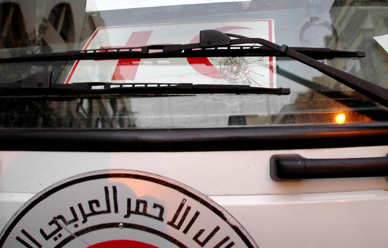 A handout picture released by the official Syrian Arab News Agency on February 8, 2014, allegedly shows a bullet impact on a Syrian Red Crescent vehicle