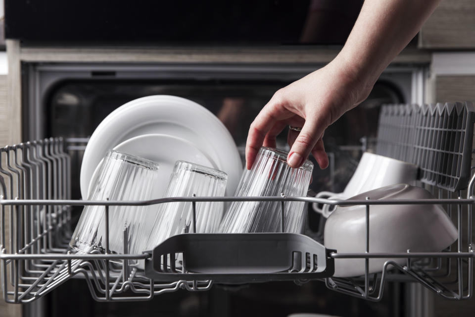 Woman unloading dishwasher