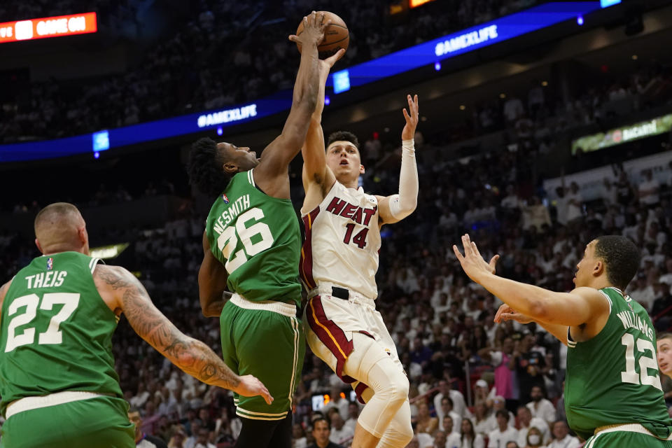 Boston Celtics forward Aaron Nesmith (26) blocks a shot to the basket by Miami Heat guard Tyler Herro (14) during the second half of Game 1 of an NBA basketball Eastern Conference finals playoff series, Tuesday, May 17, 2022, in Miami. (AP Photo/Lynne Sladky)