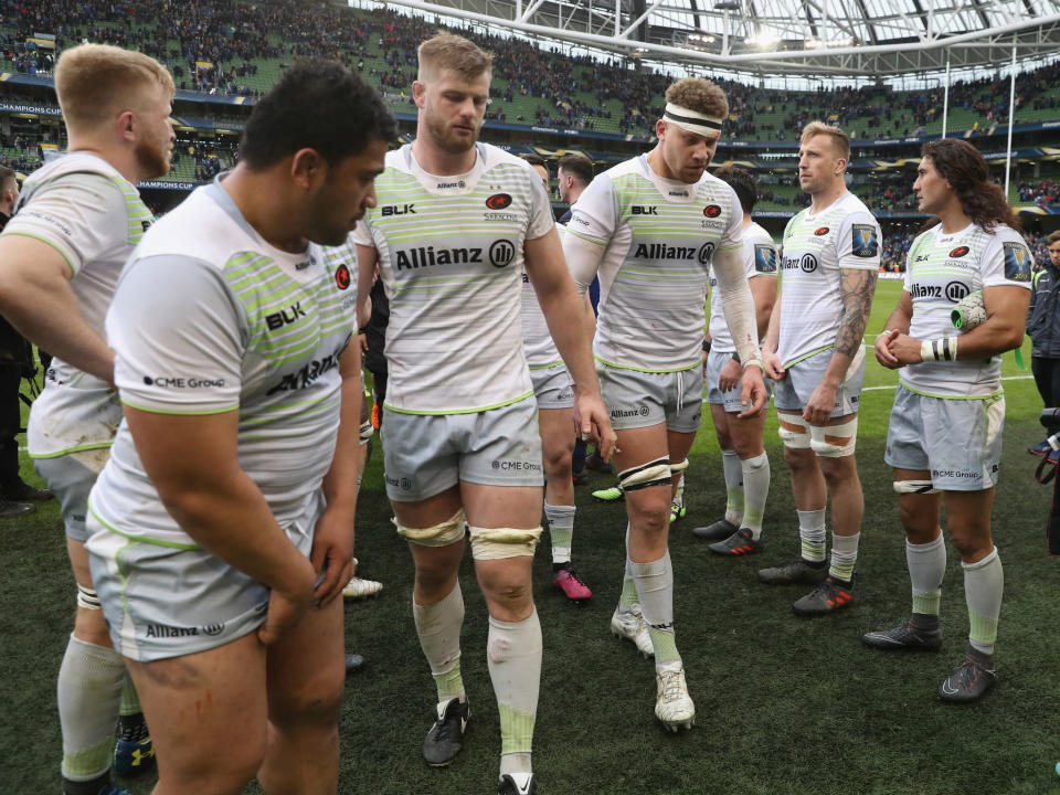 Saracens players leave the field dejected after the defeat by Leinster: Getty