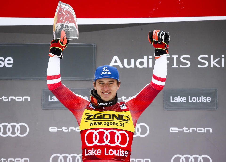 Austria's Matthias Mayer celebrates on the podium after winning the men's World Cup downhill ski race in Lake Louise, Alberta, Saturday, Nov. 27, 2021. (Jeff McIntosh/The Canadian Press via AP)