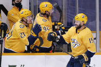 Nashville Predators right wing Brad Richardson (15) is congratulated by Nick Cousins (21) after Richardson scored a goal against the Columbus Blue Jackets in the third period of an NHL hockey game Saturday, Jan. 16, 2021, in Nashville, Tenn. The Predators won 5-2. (AP Photo/Mark Humphrey)