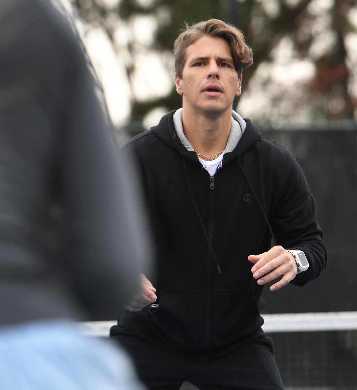 Justin Rollins of the Spartanburg Athletic Club at work training athletes on the club's tennis courts.