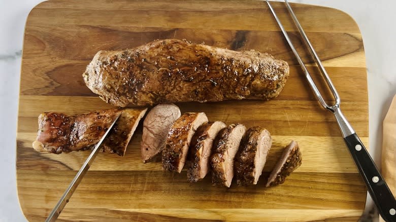 sliced roast pork on board
