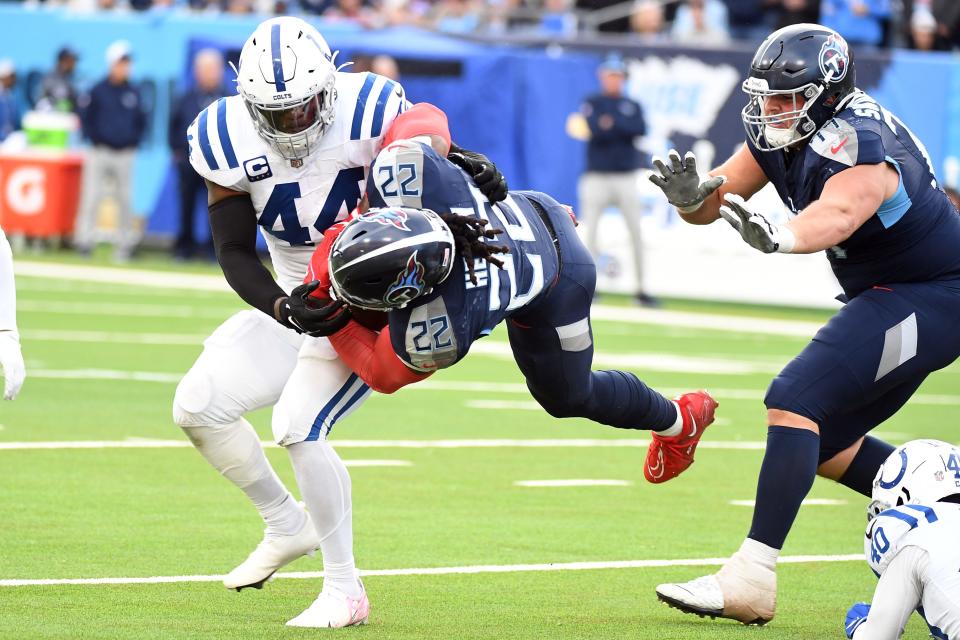 Dec 3, 2023; Nashville, Tennessee, USA; Tennessee Titans running back Derrick Henry (22) is tackled by Indianapolis Colts linebacker Zaire Franklin (44) during the second half at Nissan Stadium. Mandatory Credit: Christopher Hanewinckel-USA TODAY Sports