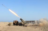 Armed militiamen loyal to Yemen's fugitive President Abderabbo Mansour Hadi launch a rocket during reported clashes with Huthi rebels in the port city of Aden's Breiqa district, on April 25, 2015