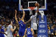 Jan 22, 2017; Orlando, FL, USA; Orlando Magic guard Elfrid Payton (4) dunks over Golden State Warriors center JaVale McGee (1) during the first quarter at Amway Center. Mandatory Credit: Kim Klement-USA TODAY Sports