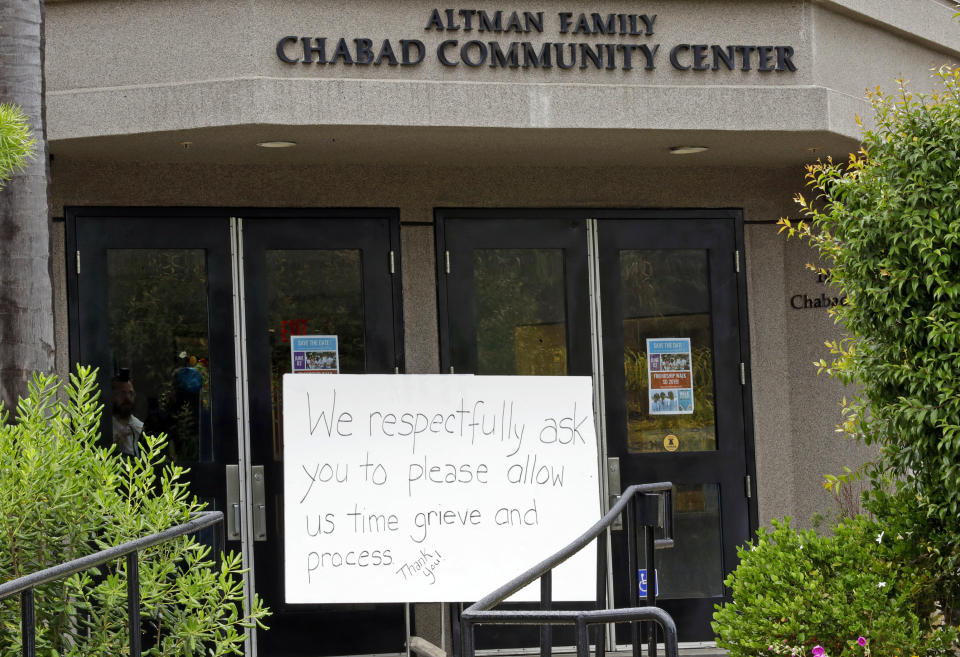 FILE - In this April 29, 2019 file photo, A sign asks for time to grieve at the Chabad of Poway synagogue in Poway, Calif. The gunman who attacked the synagogue last week fired his semi-automatic rifle at Passover worshippers after walking through the front entrance that synagogue leaders identified last year as needing improved security. The synagogue applied for a federal grant to better protect that area. The money, $150,000, was approved in September but only arrived in late March. "Obviously we did not have a chance to start using the funds yet," Rabbi Scimcha Backman told The Associated Press.(AP Photo/Gregory Bull, File)