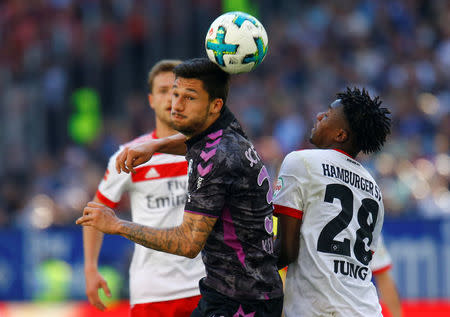 Soccer Football - Bundesliga - Hamburger SV vs SC Freiburg - Volksparkstadion, Hamburg, Germany - April 21, 2018 SC Freiburg's Tim Kleindienst in action with Hamburg's Gideon Jung REUTERS/Morris Mac Matzen