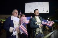 Dan Santiago, right, and Miguel Gallo, left, hold a demonstration in favor of statehood at the entrance plaza of the Santurce Fine Arts Center moments before the premiere of the award-winning Broadway musical, Hamilton, starring its creator, New York native of Puerto Rican descent Lin-Manuel Miranda, in San Juan, Puerto Rico, Friday Jan. 11, 2019. The musical is set to run for two weeks and will raise money for local arts programs. (AP Photo/Carlos Giusti)