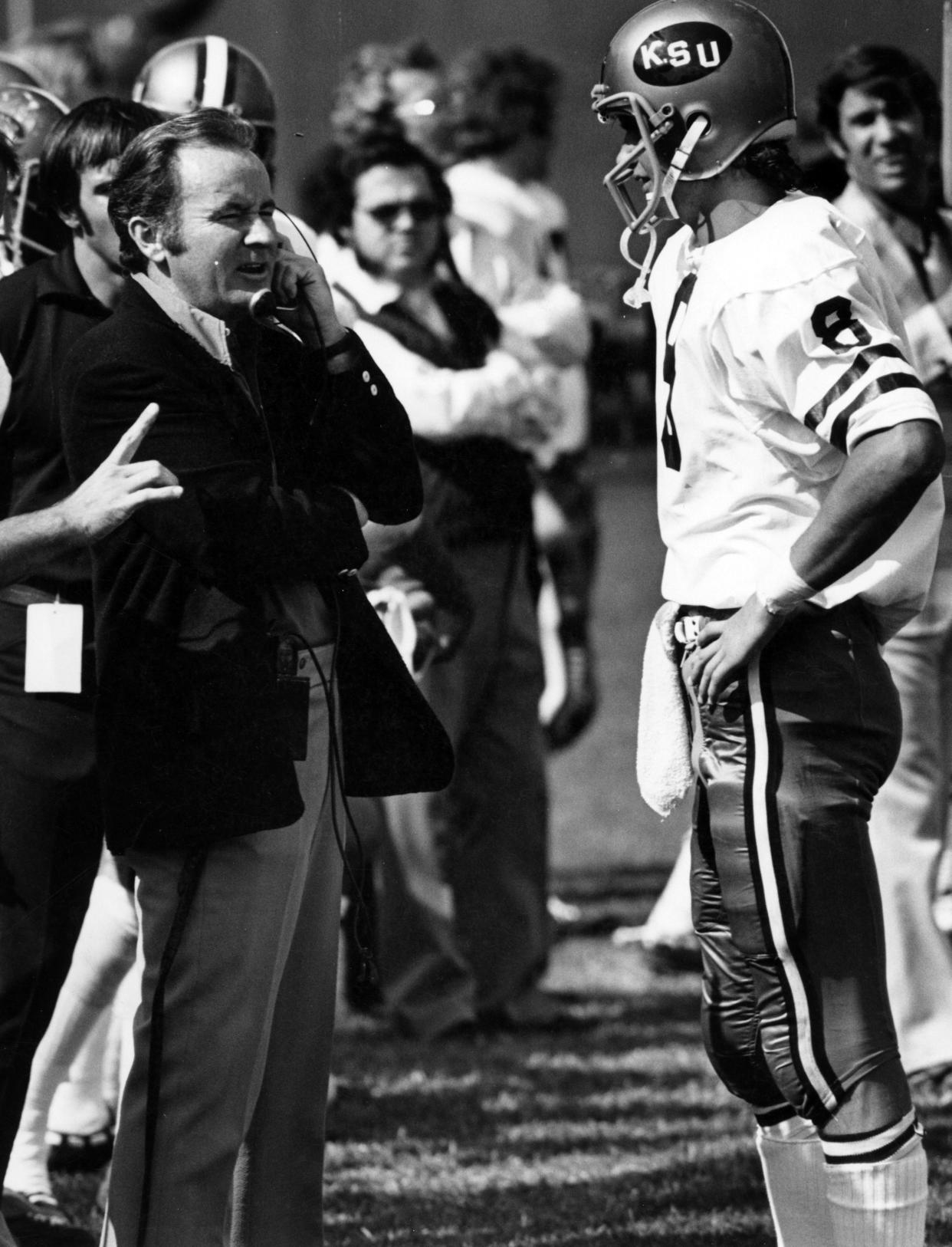 Kent State head football coach Don James talks on the sideline with quarterback Greg Kokal during a 1972 game.